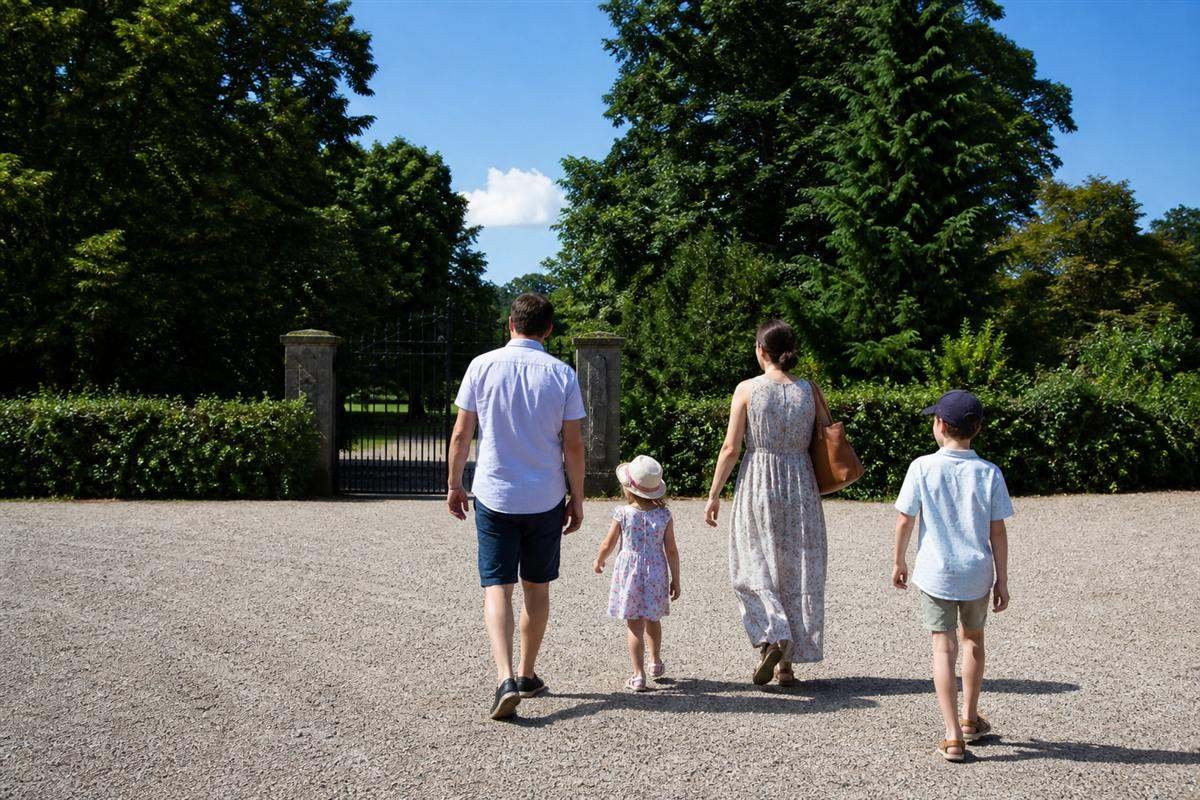 Family walking from the free car park towards the entrance gates of Cotswold Wildlife Park